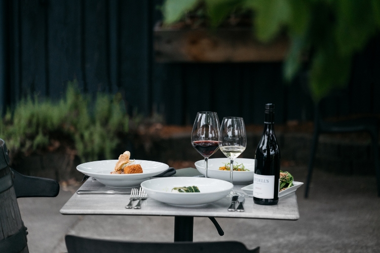 Set up for lunch in the Boydells courtyard with food and wine on the table.